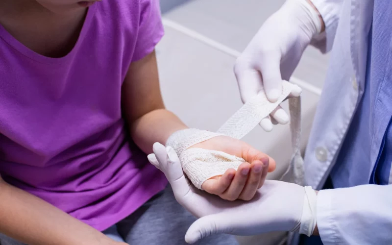 A doctor dressing a patient’s hand